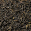 Feuilles de Sheng Cha du Plateau des Bolovens, thé pu er cru lao aux teintes noires et dorées